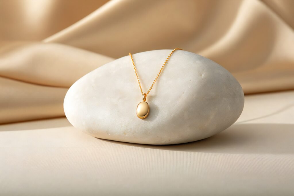 elegant gold locket necklace resting on smooth white stone with soft silk background elegant gold locket necklace resting on smooth white stone with soft silk background